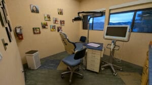A private orthodontic treatment room at Axelrode Orthodontics, featuring a dental chair, digital imaging screen, and a welcoming atmosphere with patient photos on the wall.